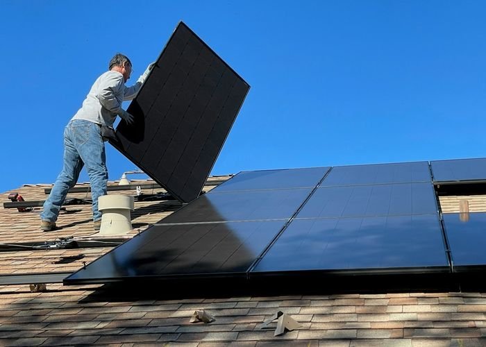 Solar panel being lifted into place